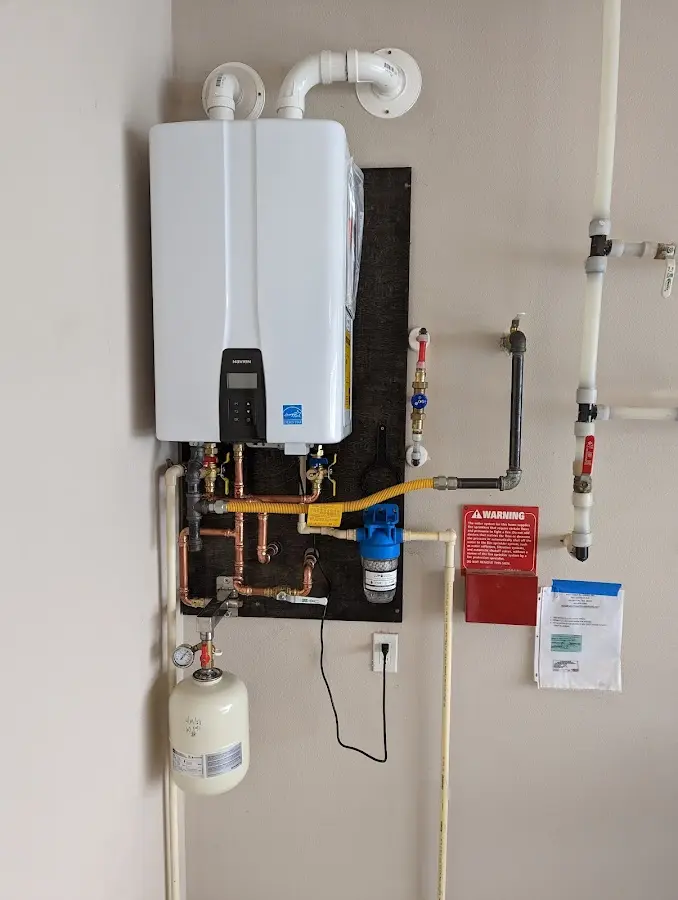 Professional plumber installing copper piping in a Pacheco home